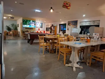 a restaurant with tables and chairs and a pool table at St Merryn in St Merryn