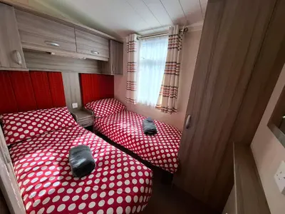 two beds in a small room with red and white polka dots at St Merryn in St Merryn