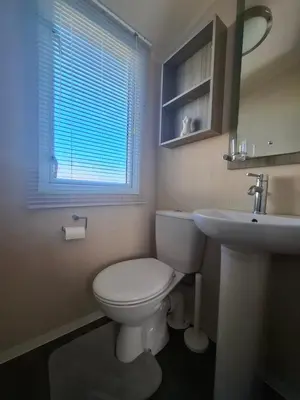 a bathroom with a white toilet and a sink at St Merryn in St Merryn