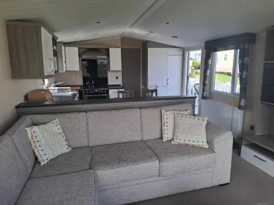 a living room with a couch and a kitchen at St Merryn in St Merryn