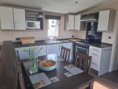 a kitchen with a table with a bowl of oranges on it at St Merryn in St Merryn