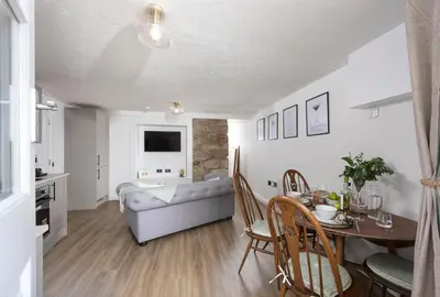 a living room with a couch and a table at City Centre 1 bed Georgian flat with courtyard in Truro