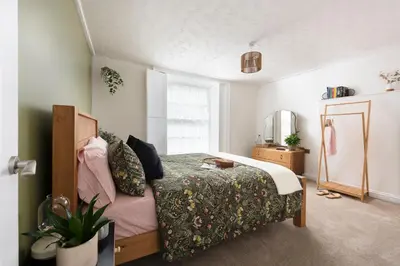 a bedroom with a bed and a mirror at City Centre 1 bed Georgian flat with courtyard in Truro