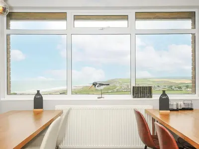 a window with a seagull sitting on a table at Atlantic Escape in Bude