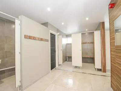 a bathroom with white walls and a walk in closet at Atlantic Escape in Bude