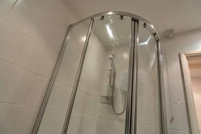 a shower with a glass door in a bathroom at Finest Retreats - Carworgie Cottage in Newquay