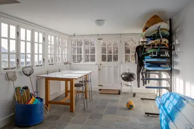 a room with a table and a shelf and windows at Penkenna House - magical home and location Saturday to Saturday bookings only 7 night min July to October in Crackington Haven