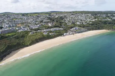 an aerial view of a beach and the ocean at Carbis Bay Lodge - Spa Facilities & Woodburner in Carbis Bay