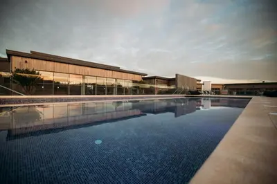 a large swimming pool in front of a building at Carbis Bay Lodge - Spa Facilities & Woodburner in Carbis Bay