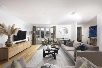 a living room with a couch and a tv at Carbis Bay Lodge - Spa Facilities & Woodburner in Carbis Bay