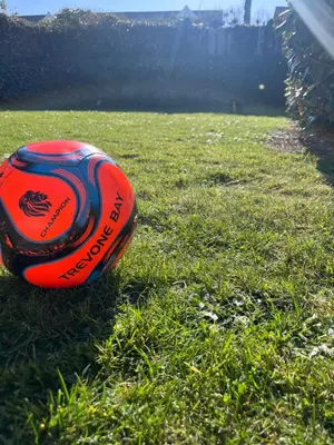 a red frisbee sitting on the grass at Trevone Holidays Kohinoor in Padstow