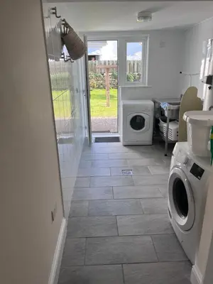 a laundry room with a washer and dryer at Trevone Holidays Kohinoor in Padstow