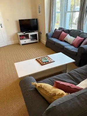 a living room with a couch and a coffee table at Trevone Holidays Kohinoor in Padstow
