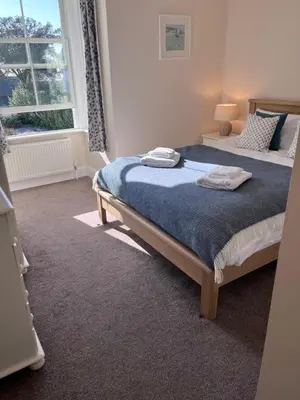 a bedroom with a bed with two towels on it at Trevone Holidays Kohinoor in Padstow