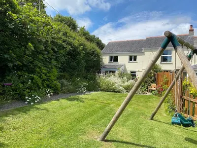 a large stick in the grass in a yard at Riverside farm cottage on private wildlife estate 1-bedroom in Washaway