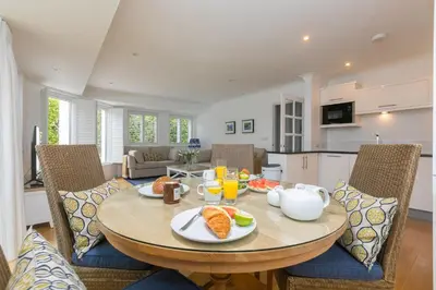 a dining room with a table with food on it at Lowena in St Ives