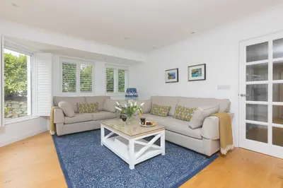 a living room with a couch and a table at Lowena in St Ives