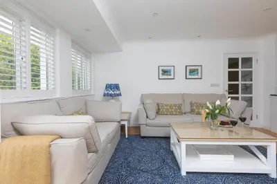 a living room with a couch and a table at Lowena in St Ives