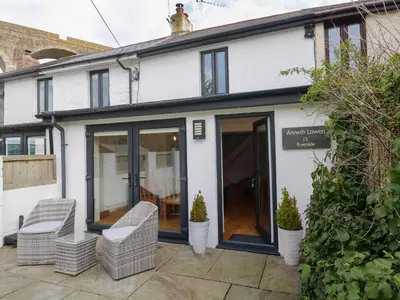 an extension to a house with glass doors at Anneth Lowen in Hayle