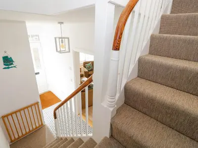 a staircase in a home with white walls at The Haven in Marazion