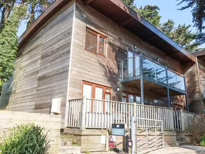 a house with a balcony on the side of it at Tincroft in Truro