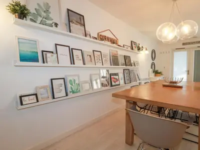 a dining room with a table and pictures on the wall at Tincroft in Truro