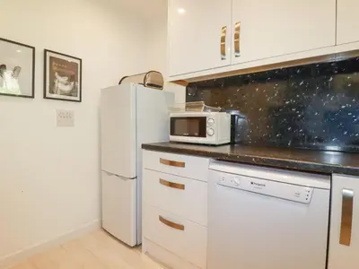 a kitchen with a white refrigerator and a microwave at Tincroft in Truro