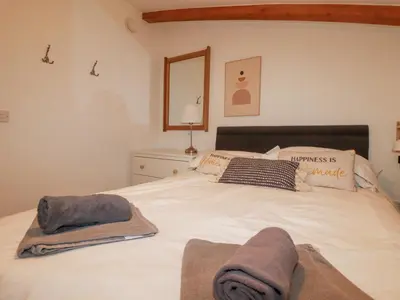 a bedroom with a bed with towels on it at Tincroft in Truro