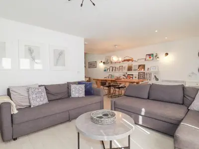 a living room with two couches and a table at Tincroft in Truro