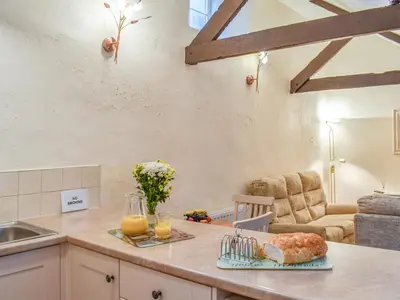 a kitchen with a counter with bread and orange juice at The Piggery - Uk49014 in Liskeard