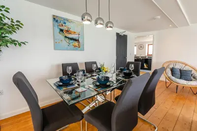 a dining room with a glass table and black chairs at 3 Bed in Coverack oc-b31082 in Coverack