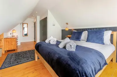 a bedroom with two beds with blue and white sheets at 3 Bed in Coverack oc-b31082 in Coverack
