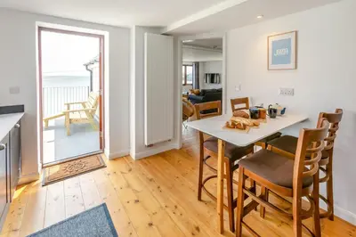 a kitchen and dining room with a table and chairs at 3 Bed in Coverack oc-b31082 in Coverack