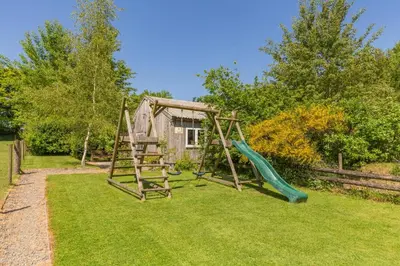 a playground with a slide in a yard at 2 Bed in Launceston oc-f30999 in Lewannick