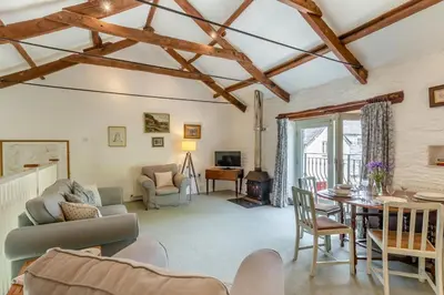 a living room with a couch and a table at 2 Bed in Launceston oc-f30999 in Lewannick