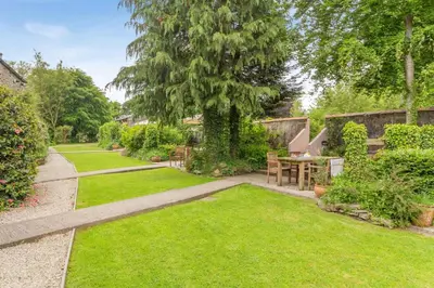 a garden with a table and chairs and a tree at 2 Bed in Launceston oc-g31003 in Lewannick