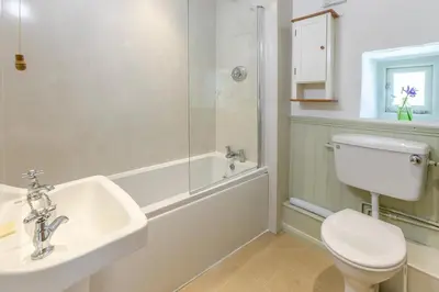a bathroom with a toilet and a sink and a shower at 3 Bed in Launceston oc-l31001 in Lewannick
