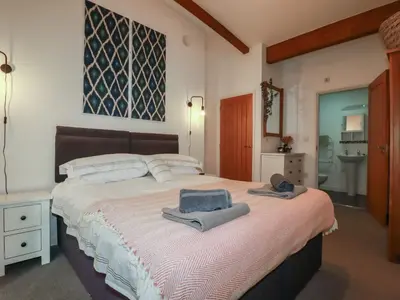 a bedroom with a large bed with towels on it at Trenethick in Truro