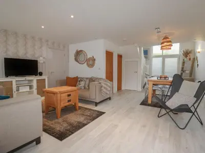 a living room with a couch and a table at Trenethick in Truro