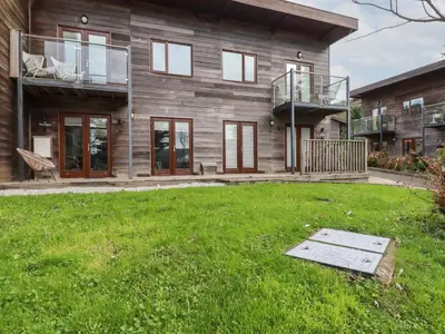a house with a lawn in front of it at Treveglos in Truro