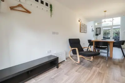 a living room with a dining room table and chairs at Treveglos in Truro