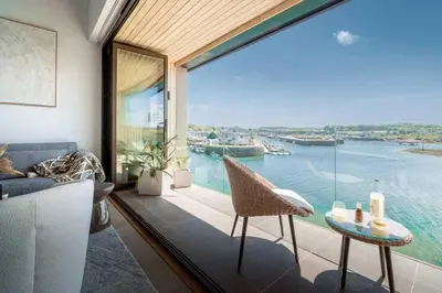 a living room with a view of the water at 3 Bedroom Luxury Waterside House in Hayle
