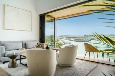 a living room with a couch and a large window at 3 Bedroom Luxury Waterside House in Hayle