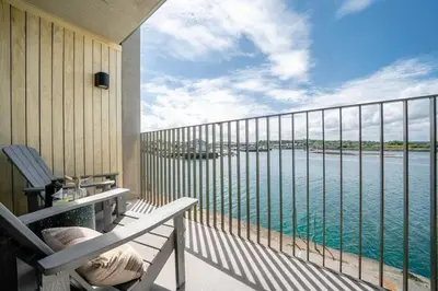 a balcony with a view of the water at 3 Bedroom Luxury Waterside House in Hayle