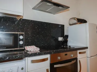 a kitchen with a microwave and a refrigerator at Tregullan in Truro