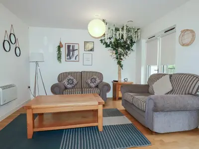 a living room with two couches and a coffee table at Tregullan in Truro