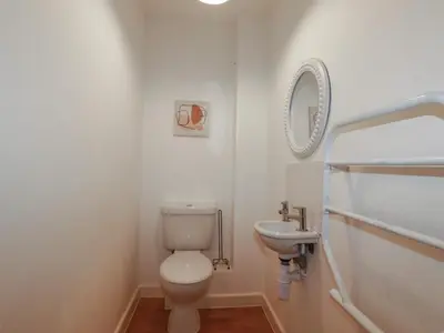 a bathroom with a toilet and a sink at Treburgett in Truro