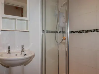 a bathroom with a sink and a shower at Treburgett in Truro
