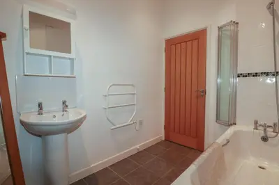 a bathroom with a sink and a toilet and a shower at Treburgett in Truro