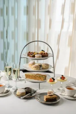 a table with plates of pastries and glasses of wine at St Moritz Hotel Houses in Polzeath